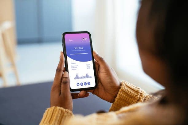 Woman viewing finance app on iPhone